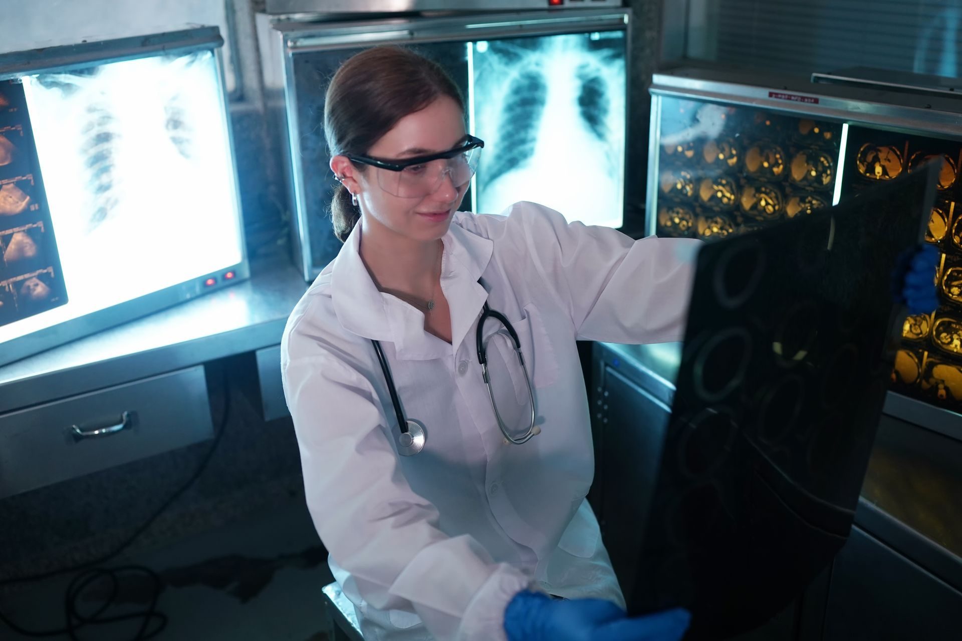 A radiographer reviewing x-ray images